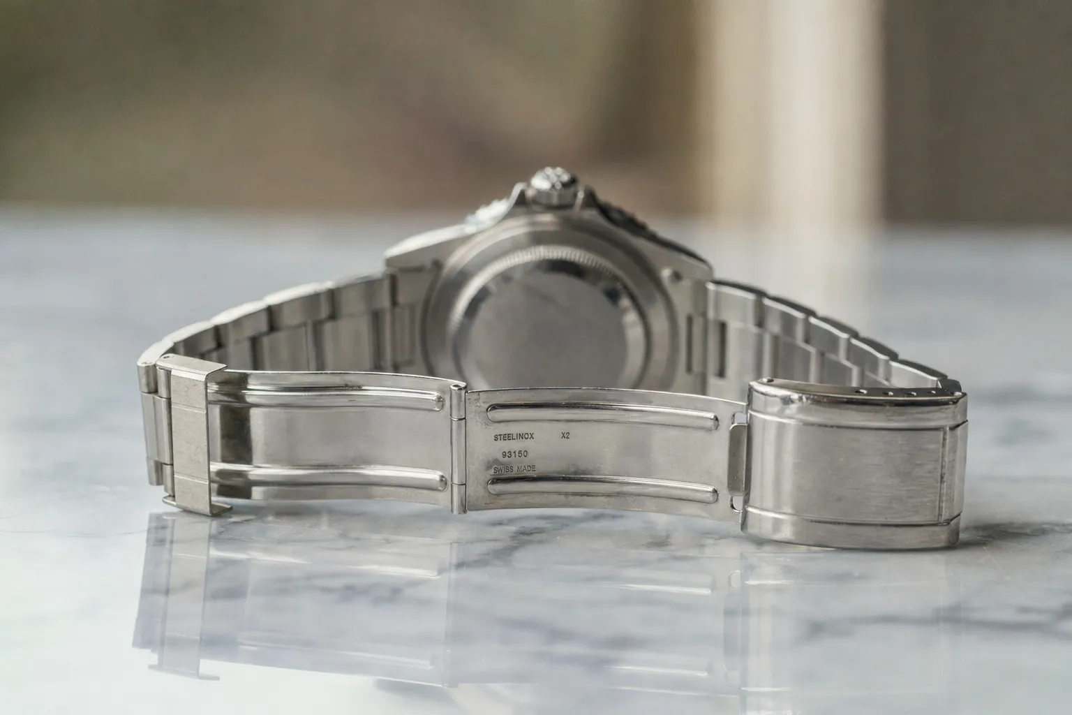 Authentic stainless steel Rolex folding clasp opened showing factory stamped clasp codes and solid end link tolerances