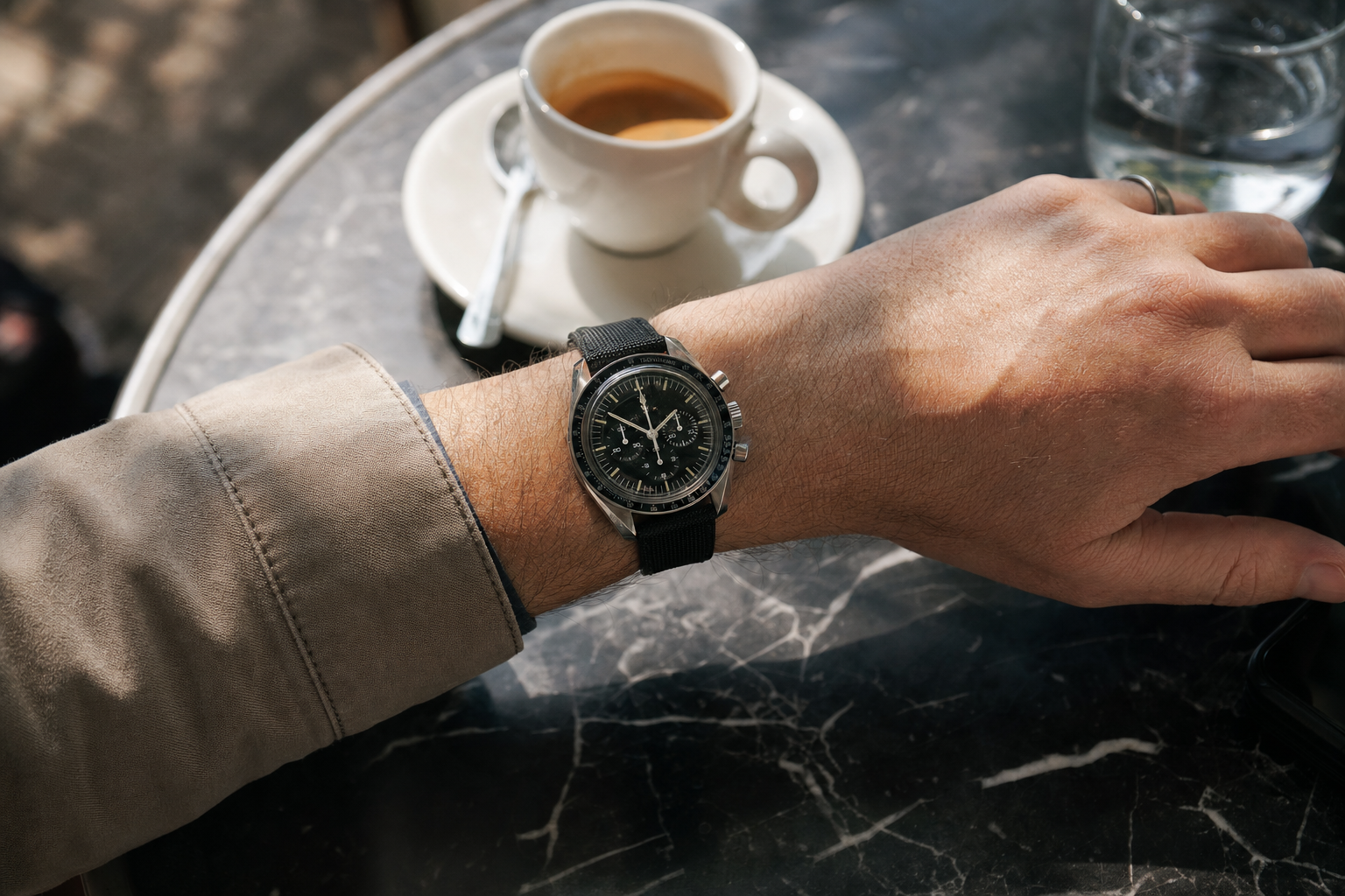 Classic Omega Speedmaster Professional worn on a wrist, featuring a black dial, tachymeter bezel, and manual-wind chronograph pushers