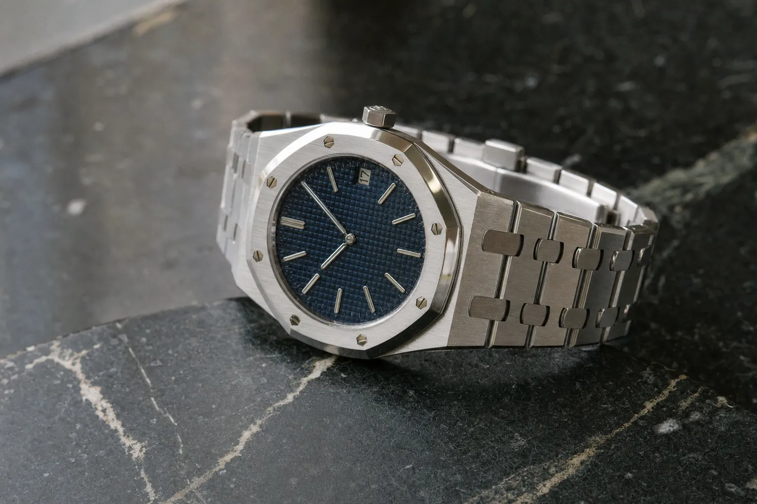 Audemars Piguet Royal Oak 'Jumbo' 16202ST on blue dial, showcasing iconic Genta design and integrated bracelet.