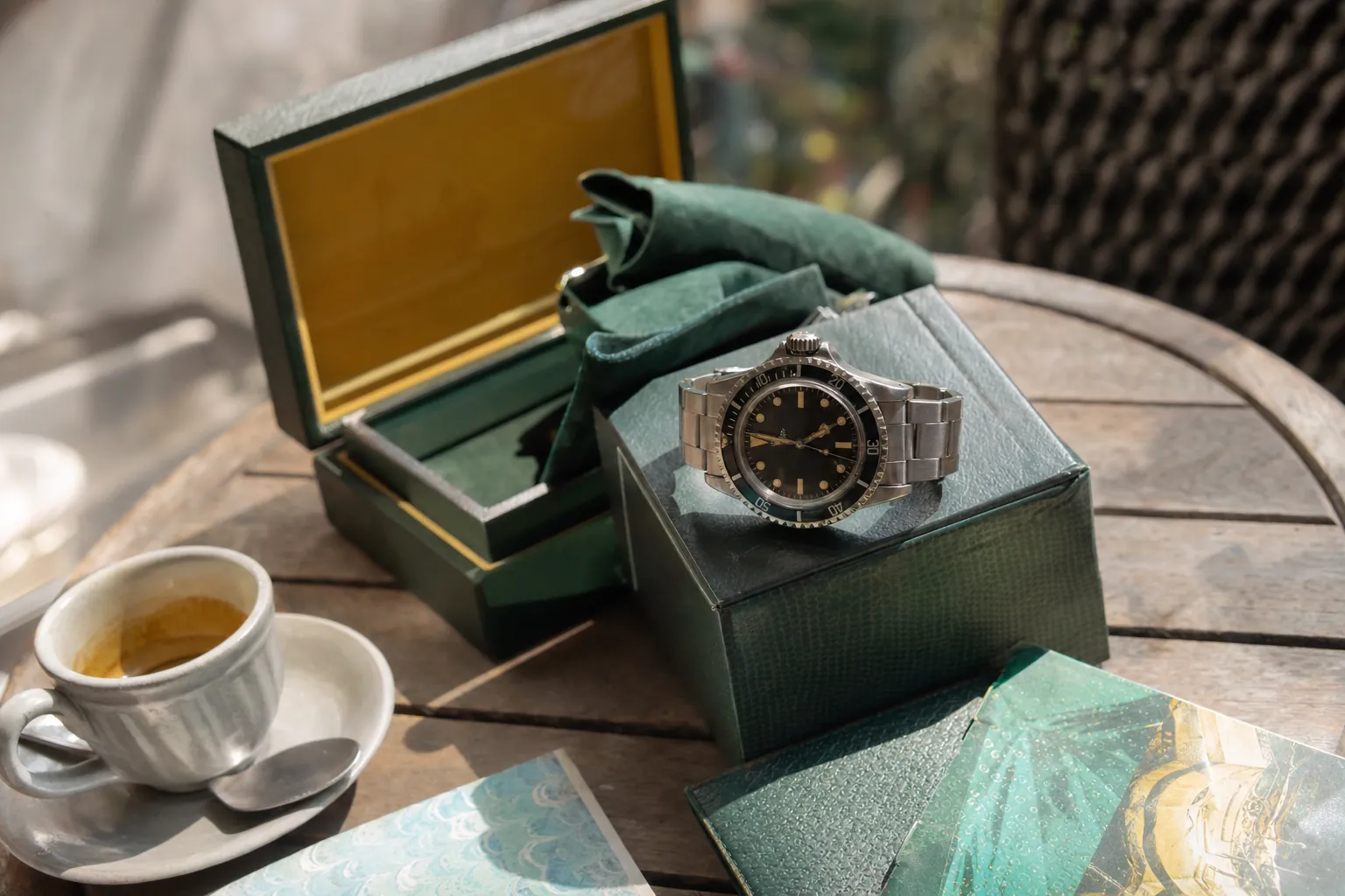 Close-up of vintage Rolex Submariner 5513 tropical dial with box and papers, illustrating pre-owned luxury watch value factors.