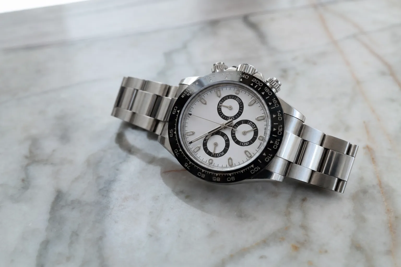 Iconic stainless steel Rolex Daytona 116500LN with white dial and ceramic bezel, a highly coveted luxury chronograph watch.