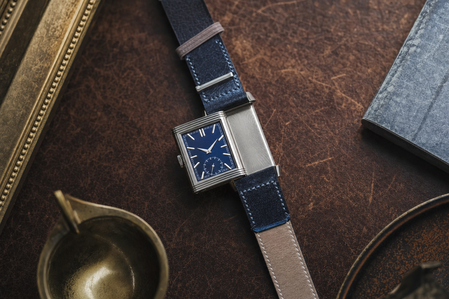 Jaeger-LeCoultre Reverso Tribute Small Seconds watch with a vibrant blue dial, solid caseback partially visible, and a brown Fagliano leather strap.