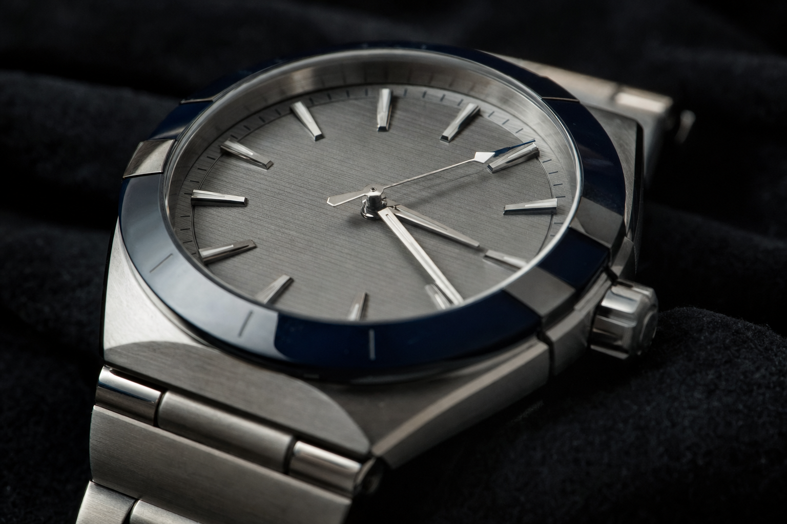 Detailed image of a modern 41mm Omega Constellation Master Chronometer in steel with blue ceramic bezel and grey dial, highlighting its signature claws.