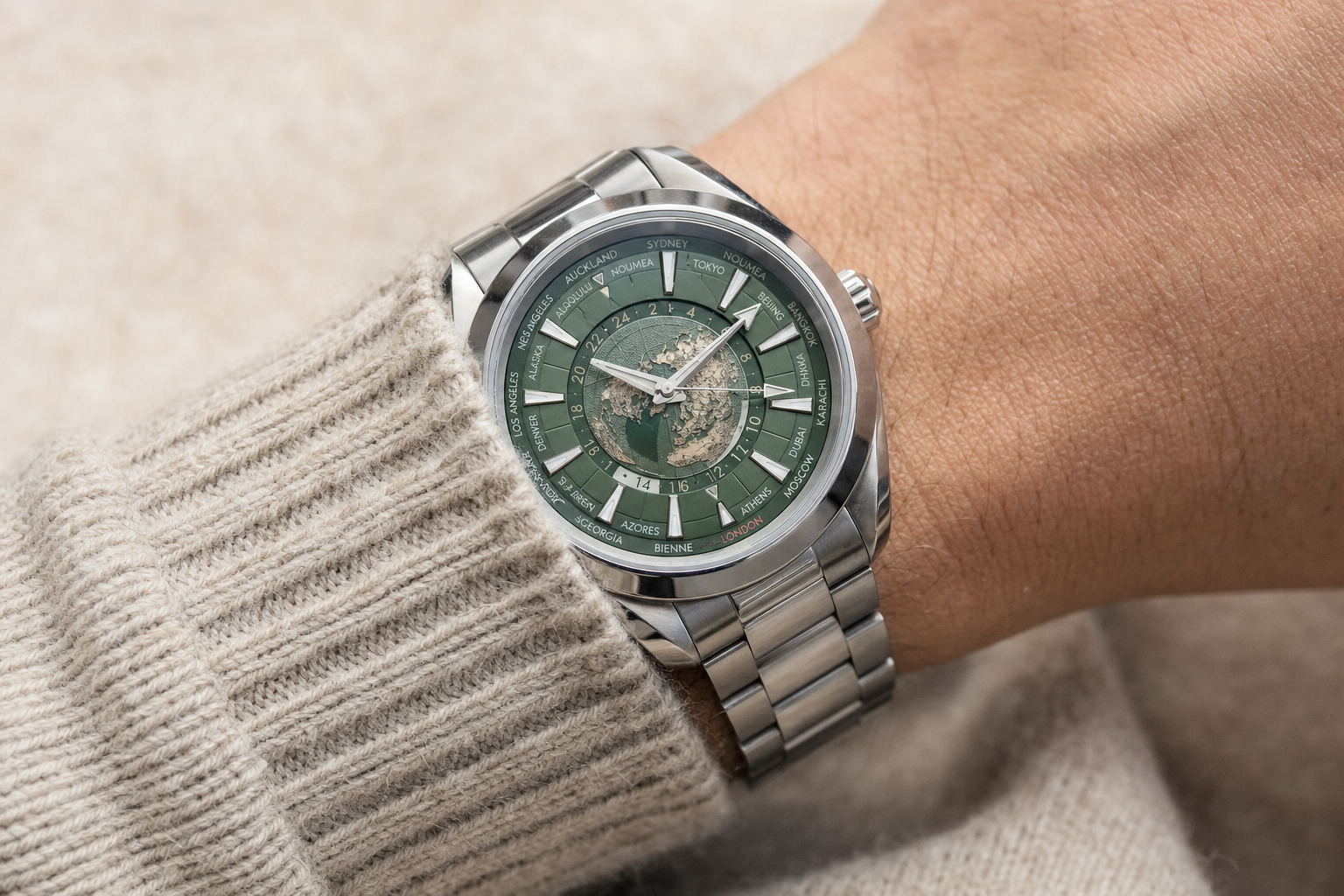 Omega Seamaster Aqua Terra Worldtimer green dial on wrist, highlighting world map feature