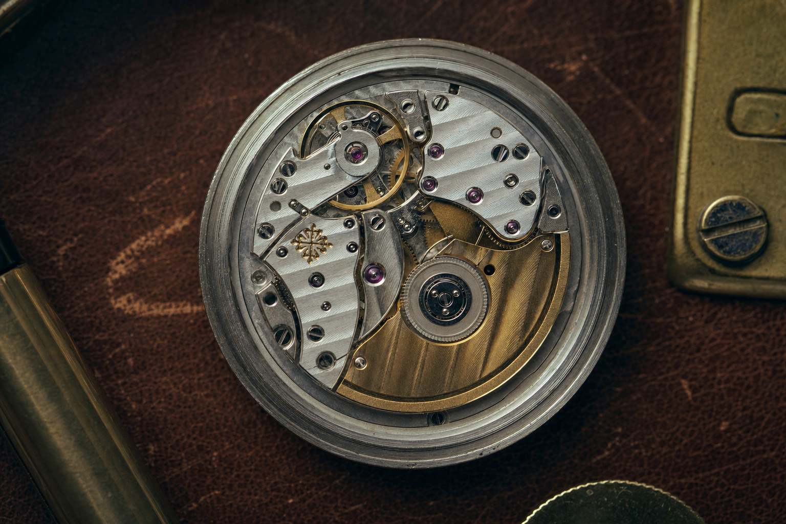 Close-up of a Patek Philippe movement with the Patek Philippe Seal visible, showcasing exquisite finishing techniques like Côtes de Genève and polished anglage.