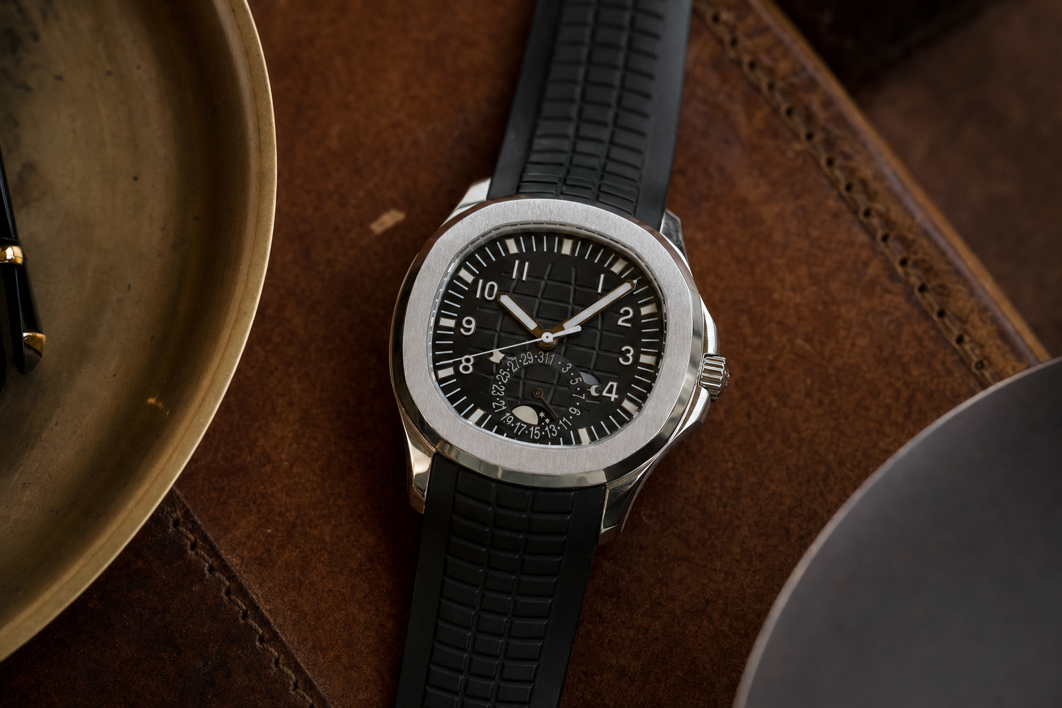 Patek Philippe Aquanaut Travel Time 5164A in stainless steel with black dial, dual hour hands, and day/night indicators on a tropical composite strap.