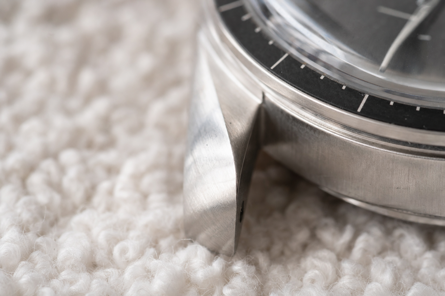 Macro view of a watch lug showing sharp edges and original brushing, indicative of excellent condition with minimal wear.