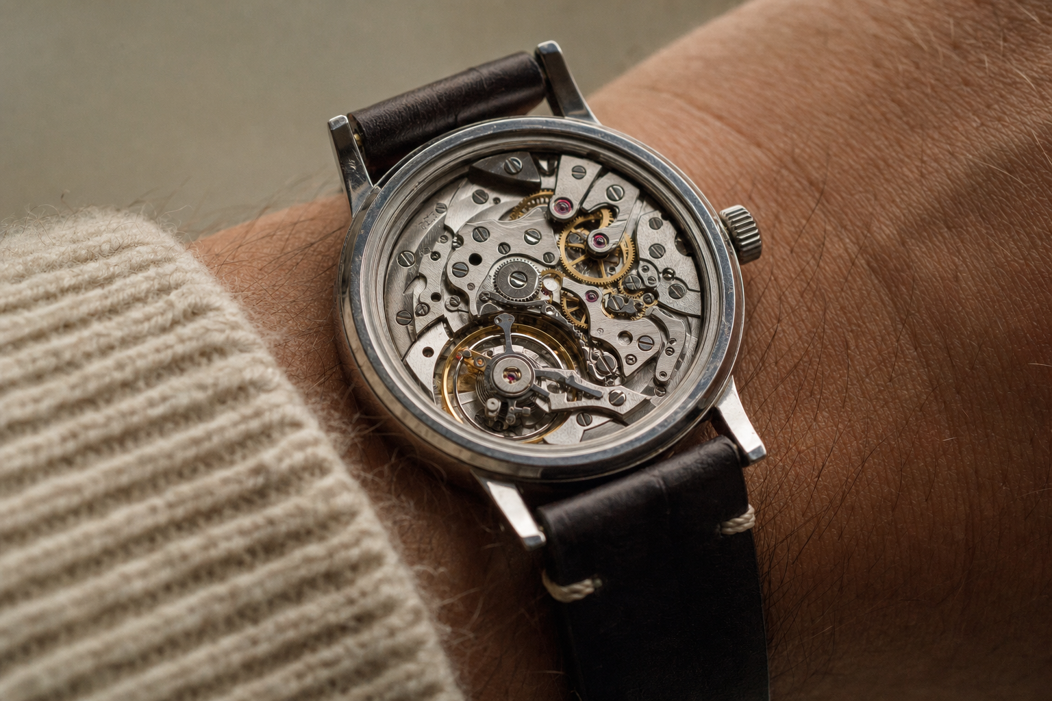 Intricate mechanical watch movement with visible gears, balance wheel, and ruby jewels under magnification, representing the complexity of horology.